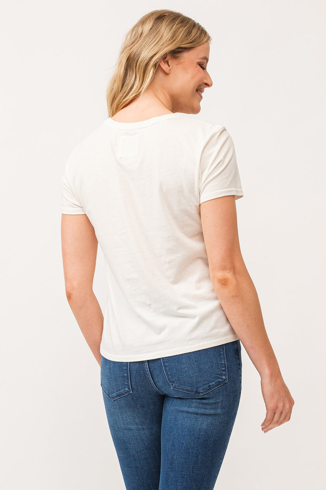 image of a female model wearing a UNITY CREW NECK SHORT SLEEVE RELAXED FIT TOP ANTIQUE WHITE DEAR JOHN DENIM 