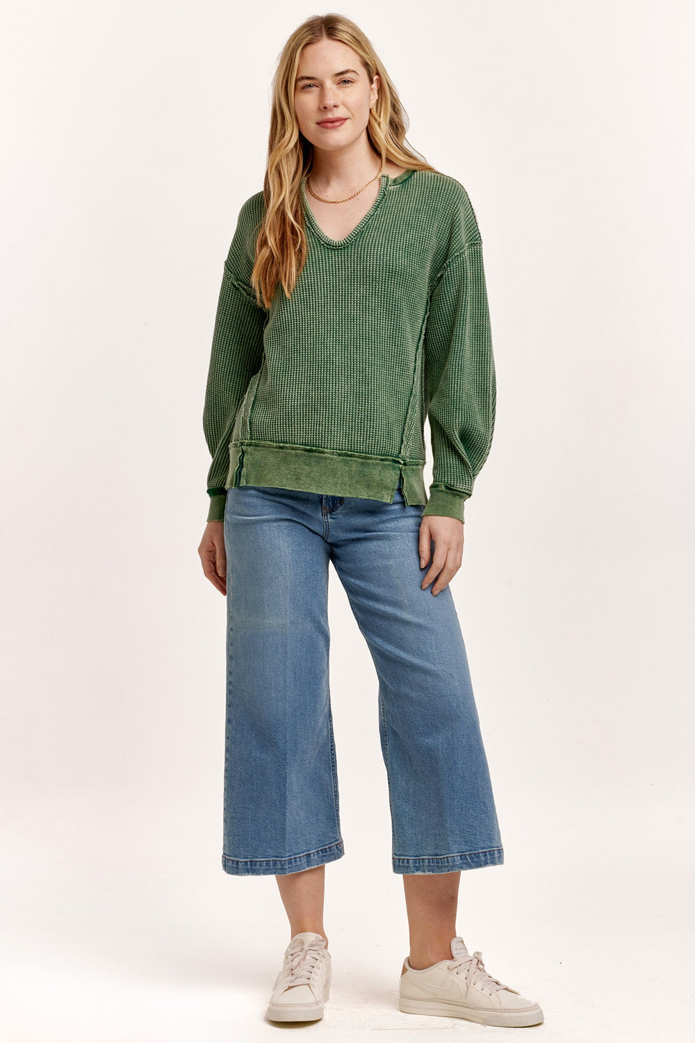 image of a female model wearing a ZYRA THERMAL OVERSIZED TOP DARK MOSS DEAR JOHN DENIM 