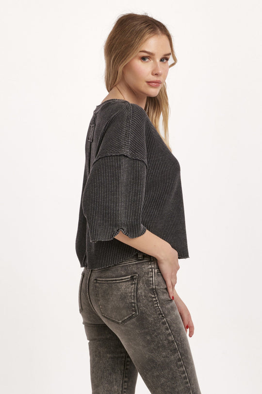 image of a female model wearing a AMIRA THERMAL WIDE SLEEVE TOP BLACK DEAR JOHN DENIM 