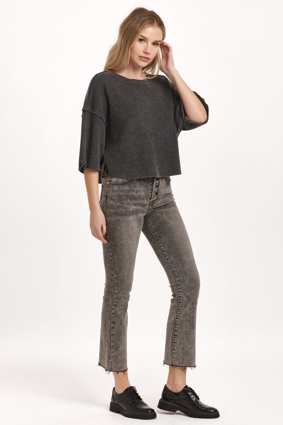 image of a female model wearing a AMIRA THERMAL WIDE SLEEVE TOP BLACK DEAR JOHN DENIM 