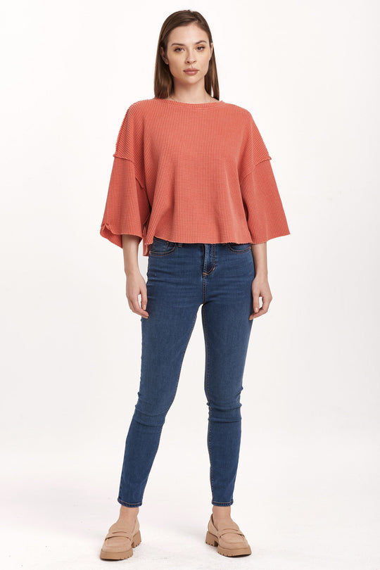 image of a female model wearing a AMIRA THERMAL WIDE SLEEVE TOP CRIMSON DEAR JOHN DENIM 