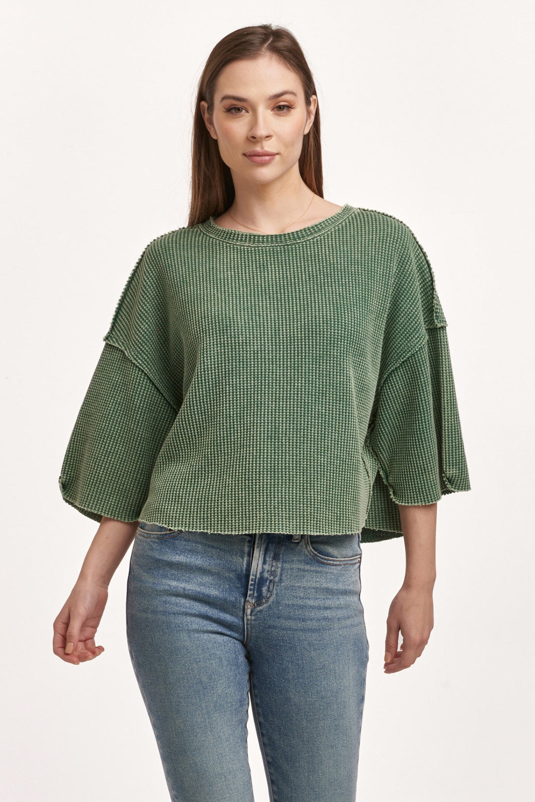 image of a female model wearing a AMIRA THERMAL WIDE SLEEVE TOP DARK MOSS DEAR JOHN DENIM 