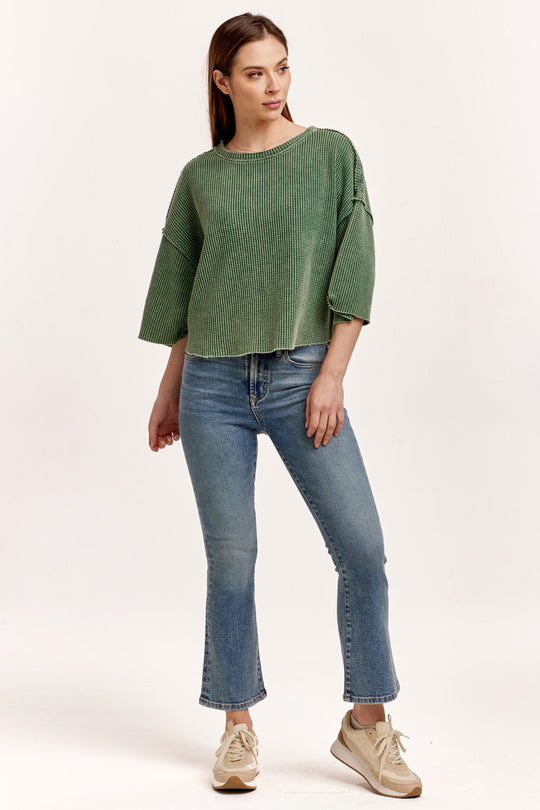 image of a female model wearing a AMIRA THERMAL WIDE SLEEVE TOP DARK MOSS DEAR JOHN DENIM 