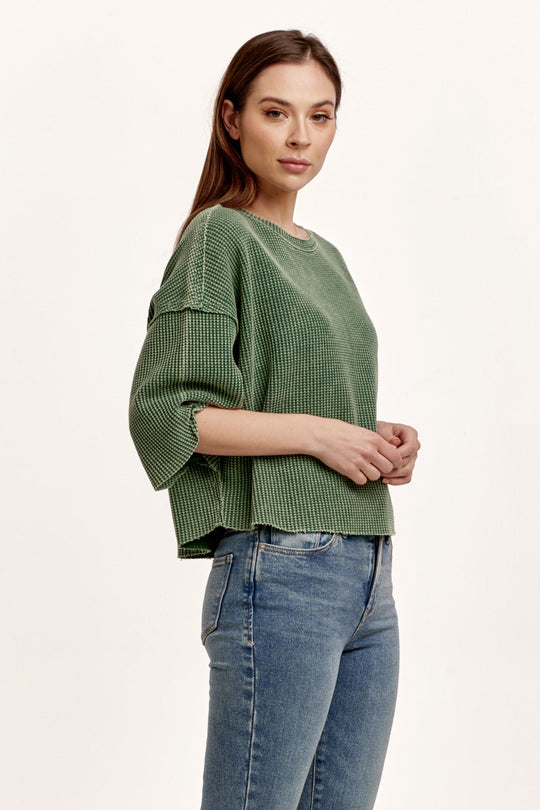 image of a female model wearing a AMIRA THERMAL WIDE SLEEVE TOP DARK MOSS DEAR JOHN DENIM 