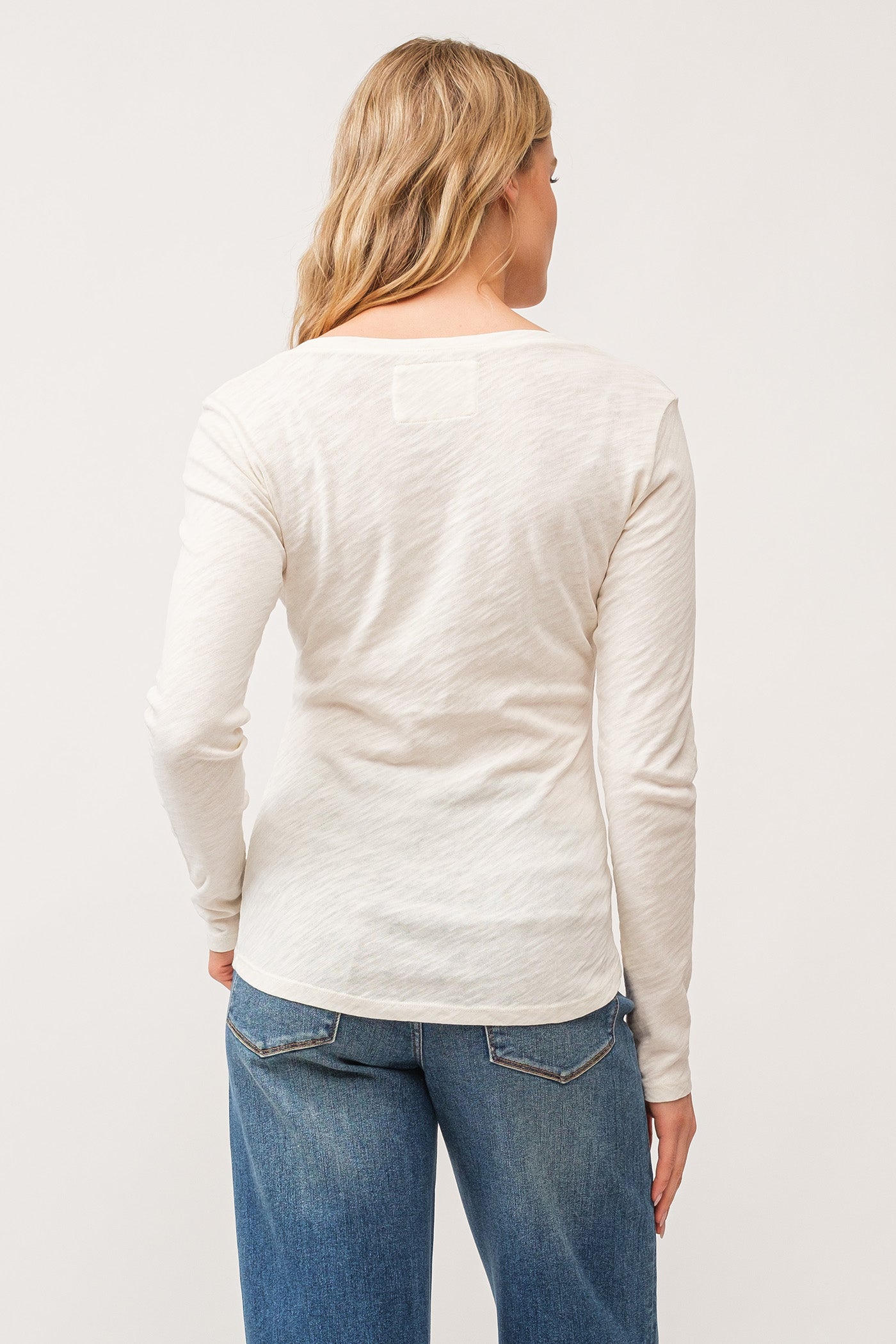 image of a female model wearing a ALINA V-NECK LONG SLEEVE CLASSIC FIT TOP ANTIQUE WHITE DEAR JOHN DENIM 