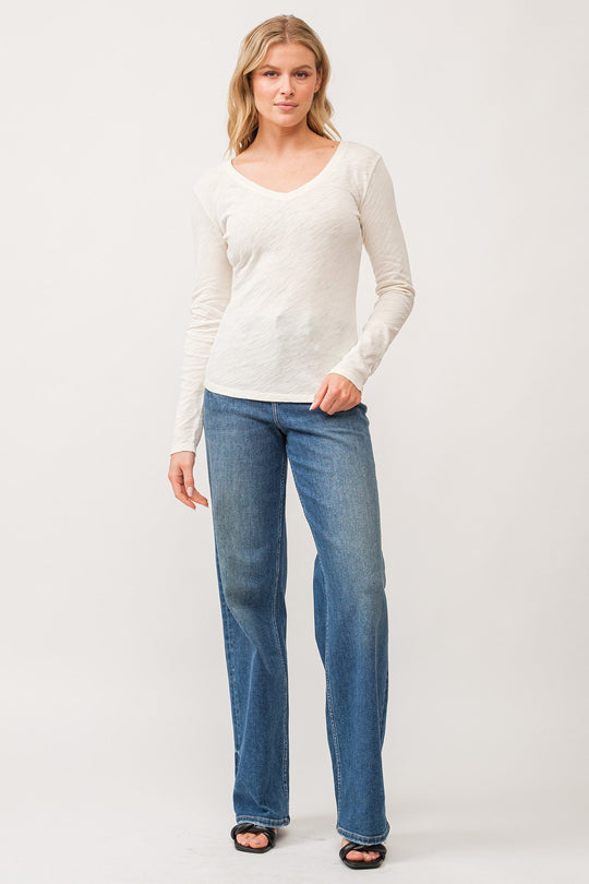 image of a female model wearing a ALINA V-NECK LONG SLEEVE CLASSIC FIT TOP ANTIQUE WHITE DEAR JOHN DENIM 