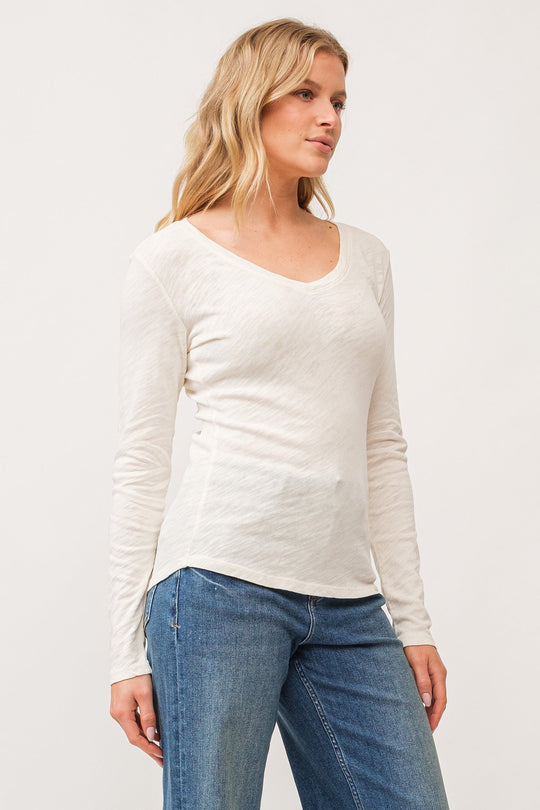 image of a female model wearing a ALINA V-NECK LONG SLEEVE CLASSIC FIT TOP ANTIQUE WHITE DEAR JOHN DENIM 