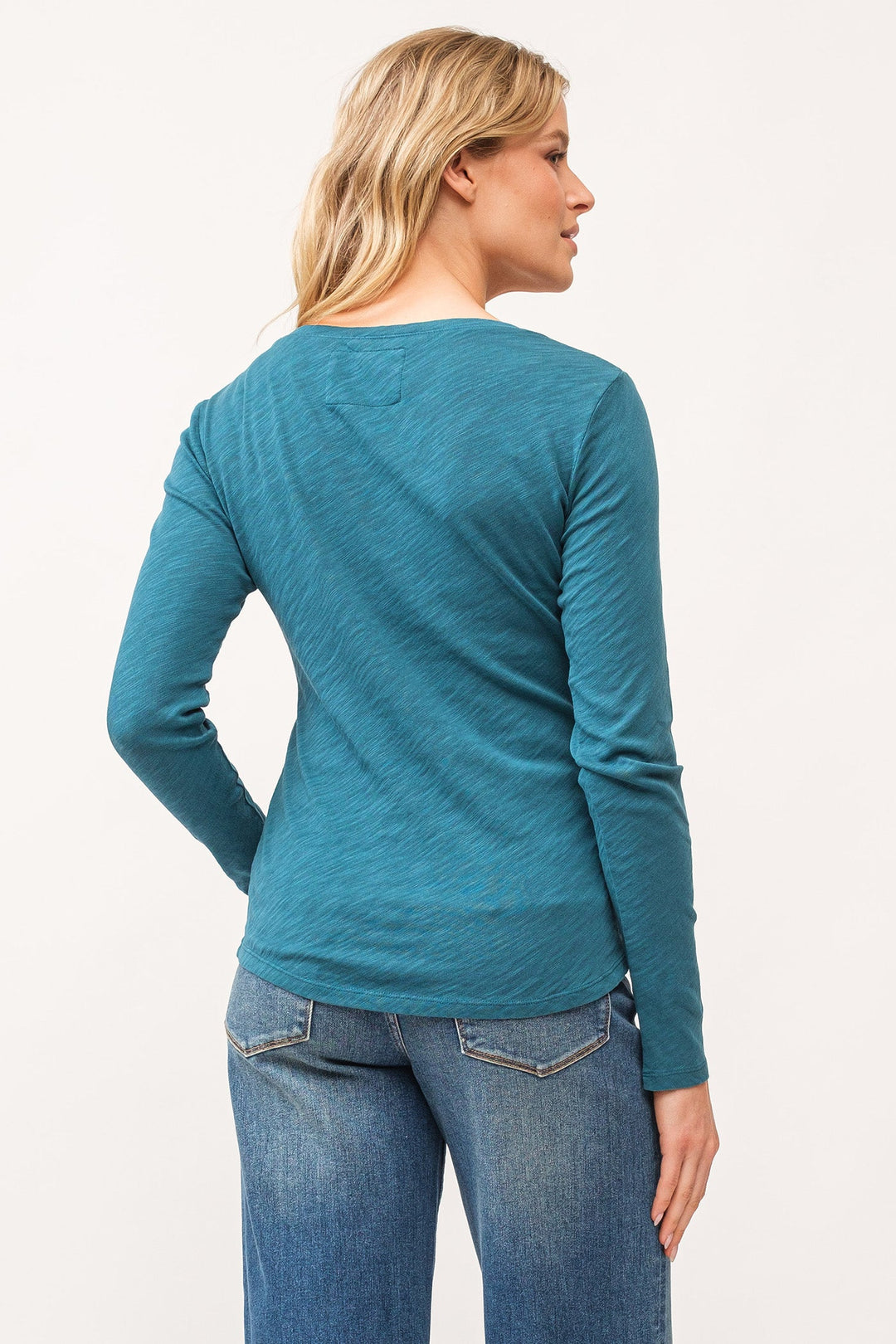 image of a female model wearing a ALINA V-NECK LONG SLEEVE CLASSIC FIT TOP DEEP TEAL DEAR JOHN DENIM 