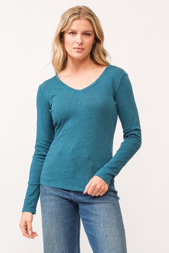 image of a female model wearing a ALINA V-NECK LONG SLEEVE CLASSIC FIT TOP DEEP TEAL DEAR JOHN DENIM 