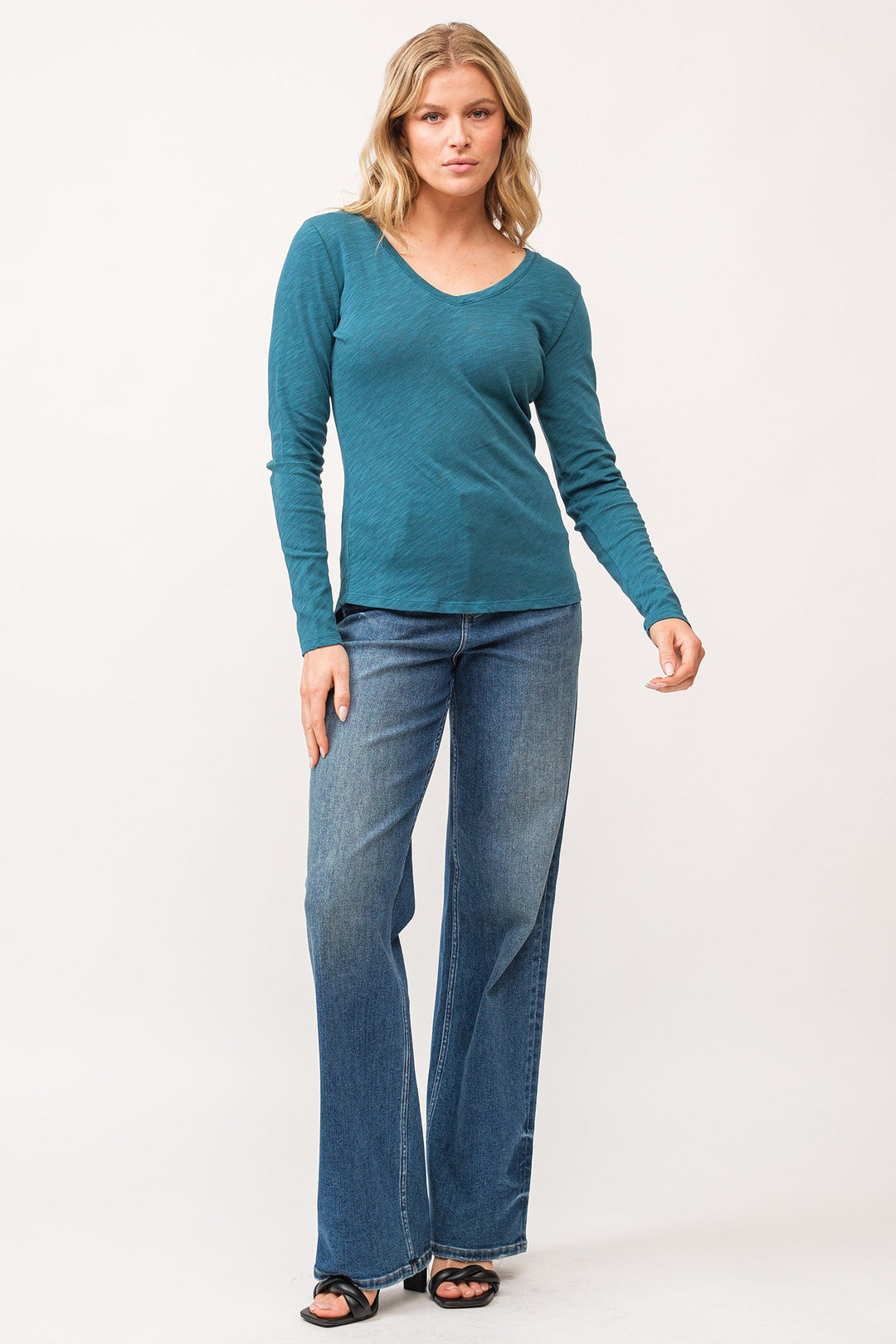 image of a female model wearing a ALINA V-NECK LONG SLEEVE CLASSIC FIT TOP DEEP TEAL DEAR JOHN DENIM 