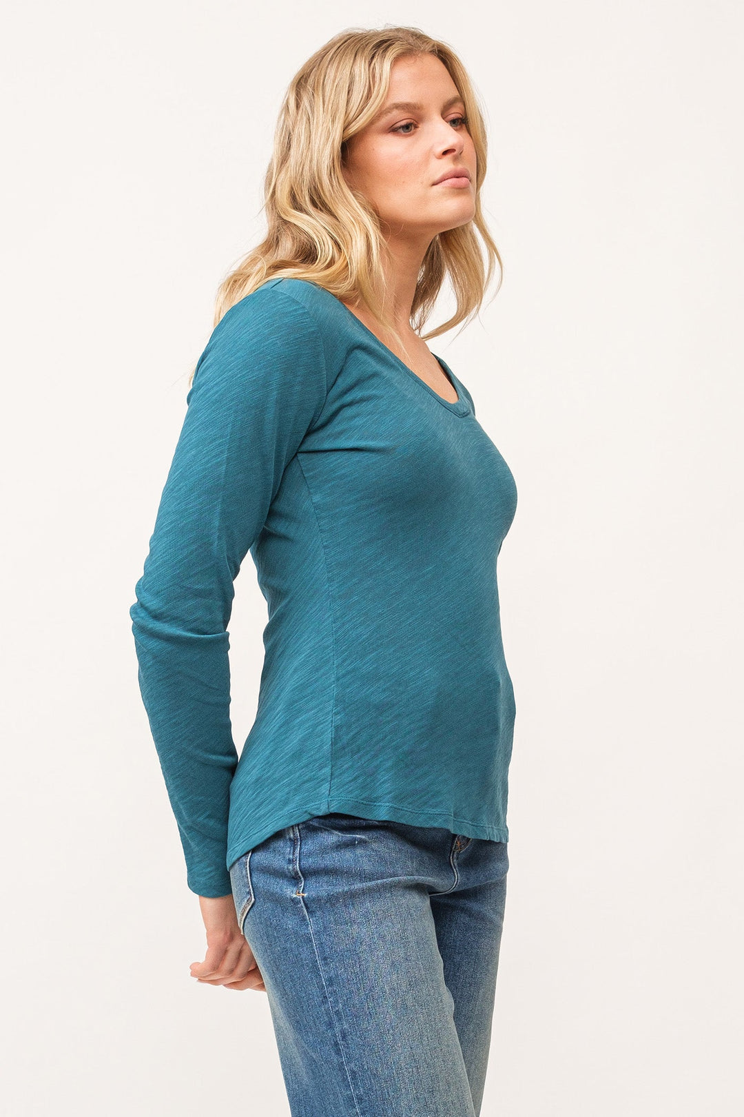 image of a female model wearing a ALINA V-NECK LONG SLEEVE CLASSIC FIT TOP DEEP TEAL DEAR JOHN DENIM 