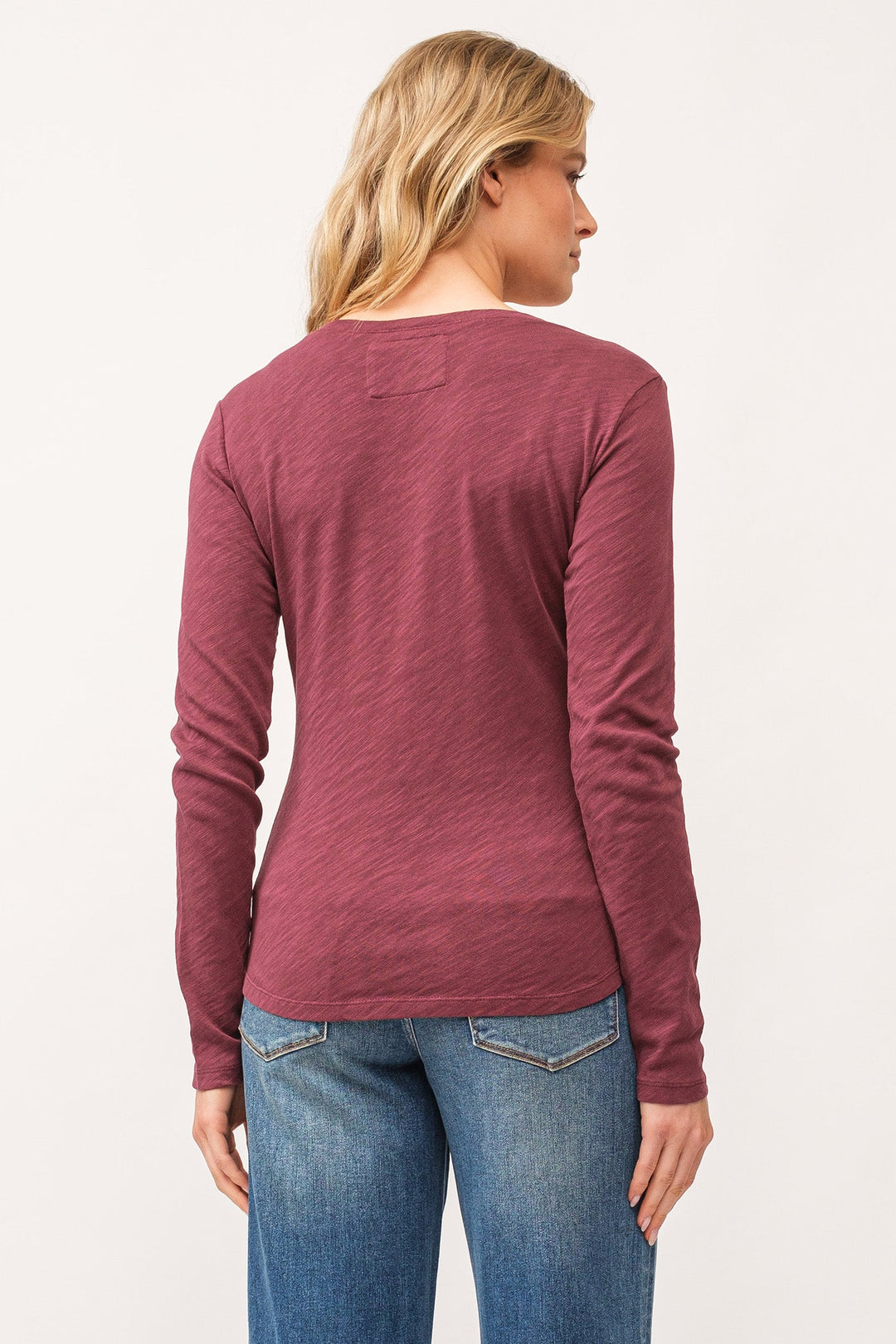 image of a female model wearing a ALINA V-NECK LONG SLEEVE CLASSIC FIT TOP POMEGRANATE DEAR JOHN DENIM 