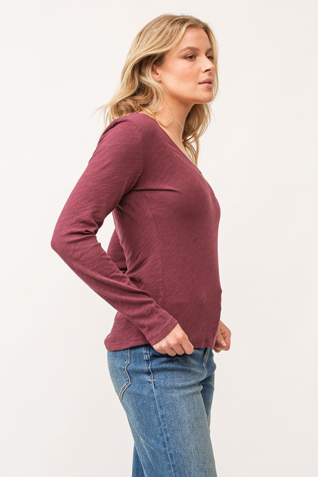 image of a female model wearing a ALINA V-NECK LONG SLEEVE CLASSIC FIT TOP POMEGRANATE DEAR JOHN DENIM 