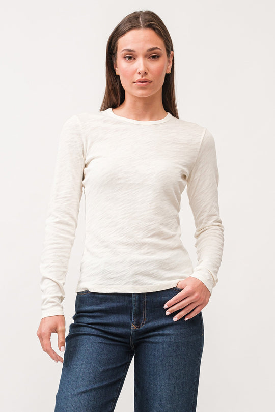 image of a female model wearing a NINA CREW NECK LONG SLEEVE CLASSIC FIT TOP ANTIQUE WHITE DEAR JOHN DENIM 