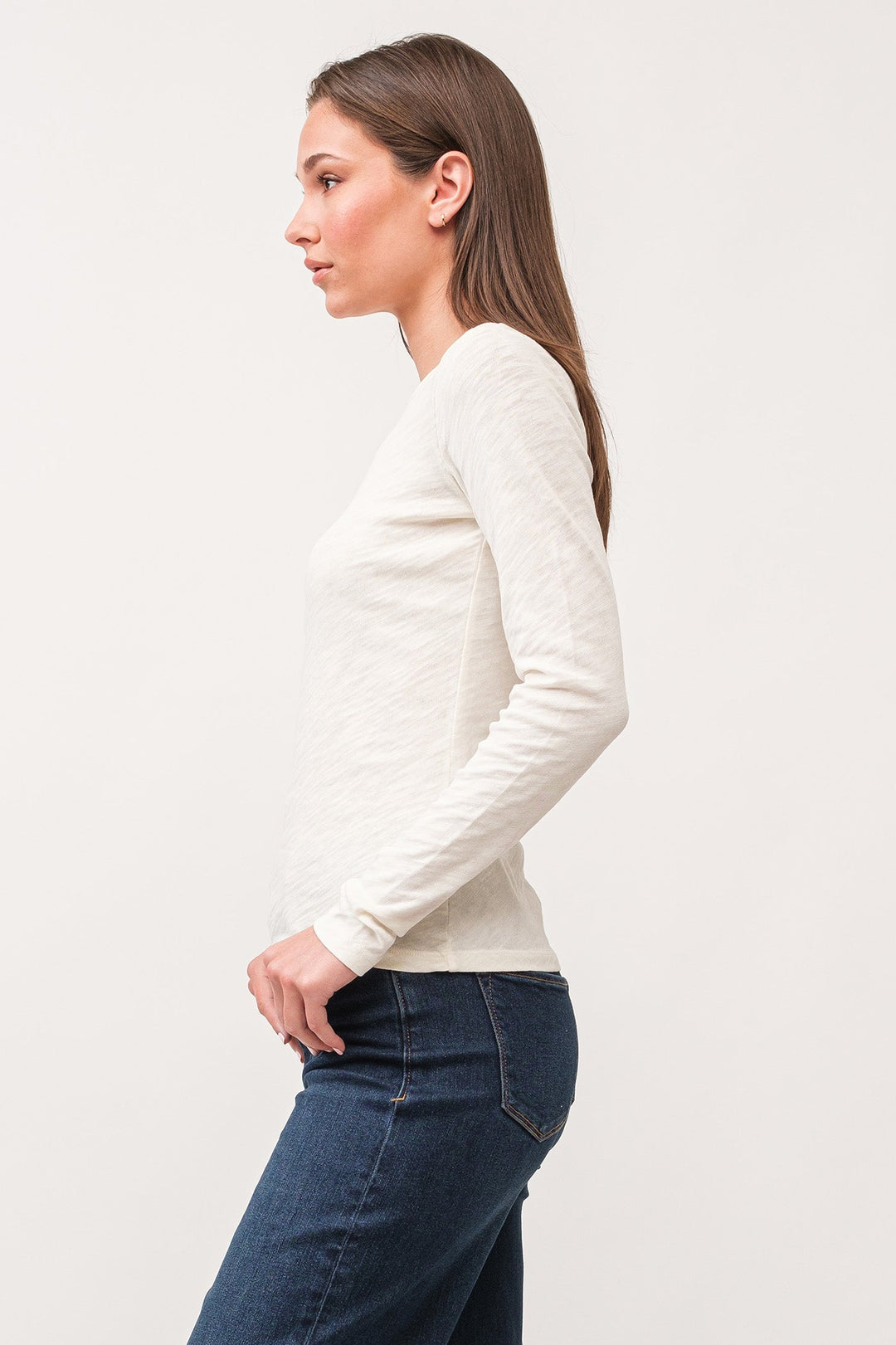 image of a female model wearing a NINA CREW NECK LONG SLEEVE CLASSIC FIT TOP ANTIQUE WHITE DEAR JOHN DENIM 