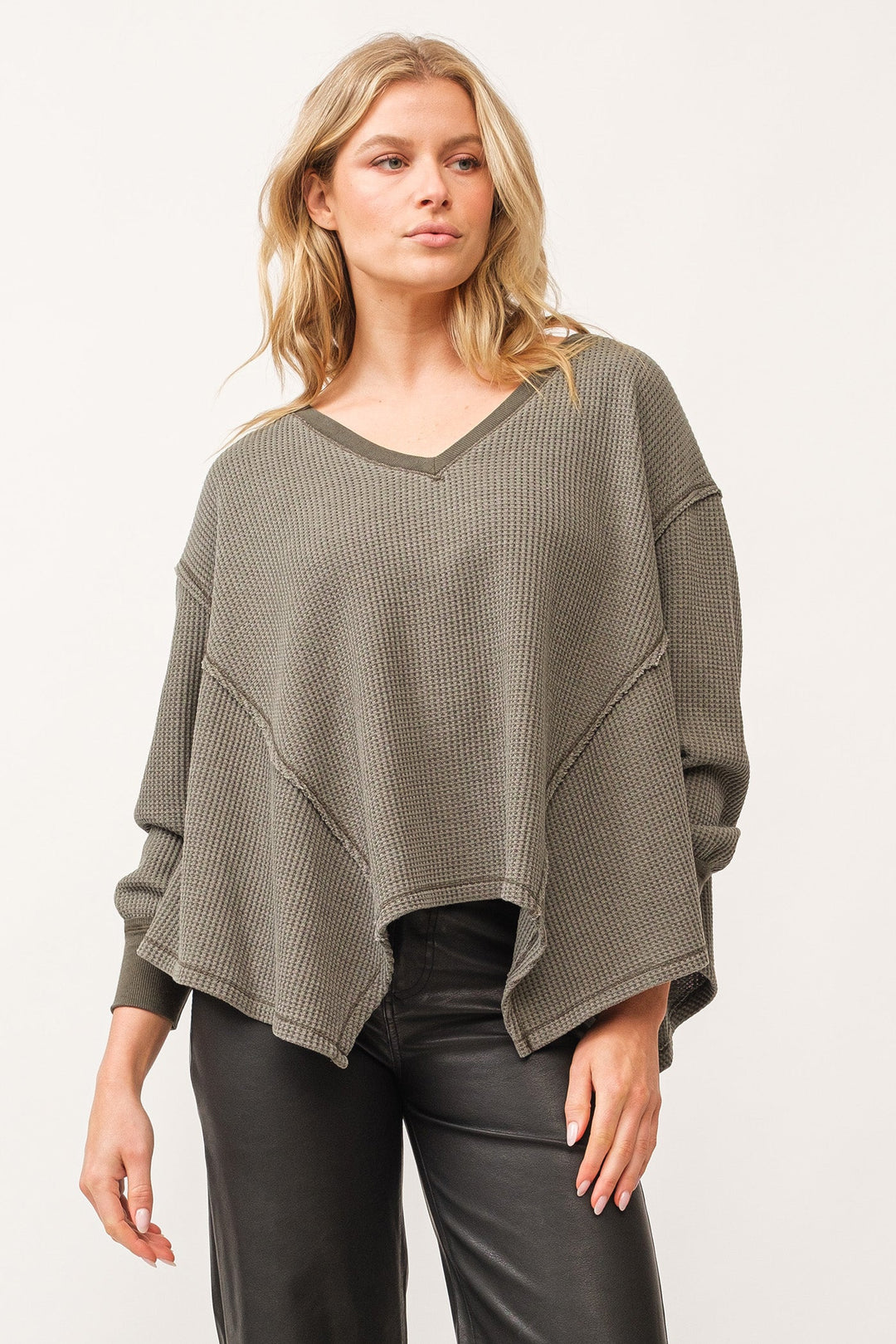 image of a female model wearing a MIRA V-NECK OVERSIZED LONG SLEEVE TOP DARK OLIVE DEAR JOHN DENIM 