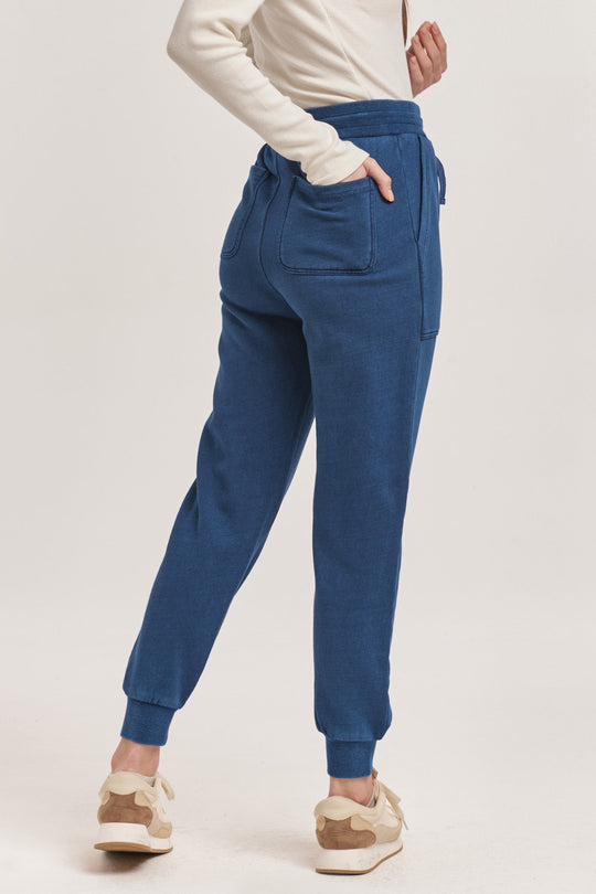 image of a female model wearing a DAHLIA HIGH RISE ANKLE JOGGER PANTS DARK INDIGO DEAR JOHN DENIM 