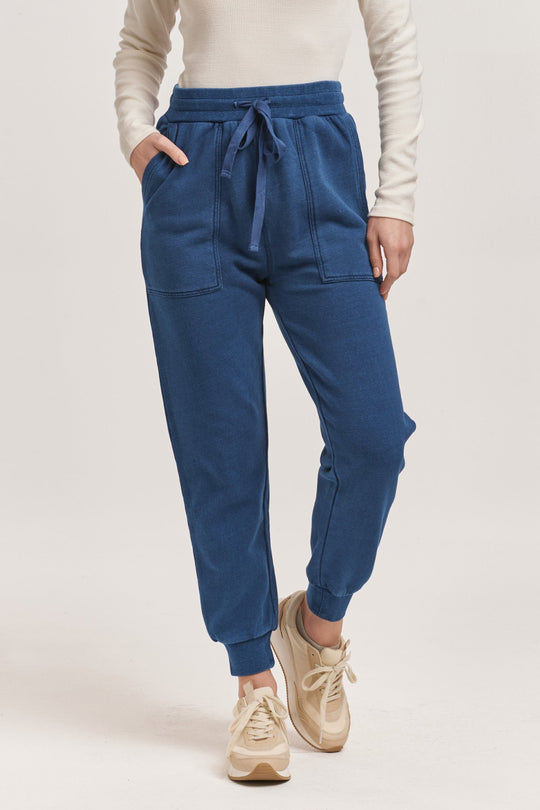 image of a female model wearing a DAHLIA HIGH RISE ANKLE JOGGER PANTS DARK INDIGO DEAR JOHN DENIM 