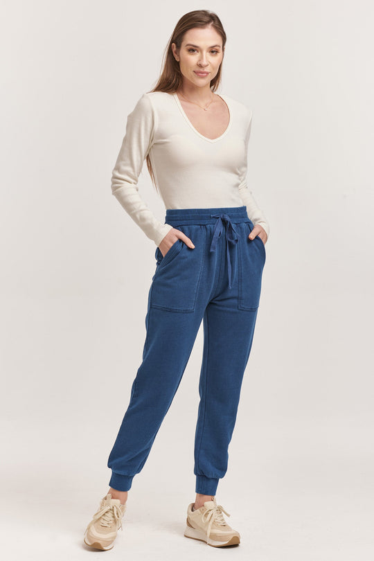 image of a female model wearing a DAHLIA HIGH RISE ANKLE JOGGER PANTS DARK INDIGO DEAR JOHN DENIM 