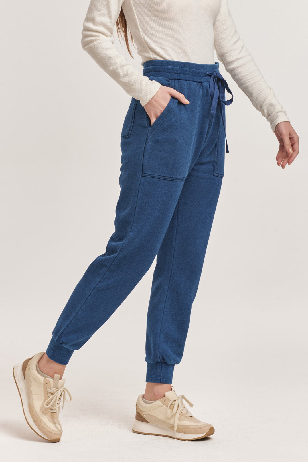 image of a female model wearing a DAHLIA HIGH RISE ANKLE JOGGER PANTS DARK INDIGO DEAR JOHN DENIM 