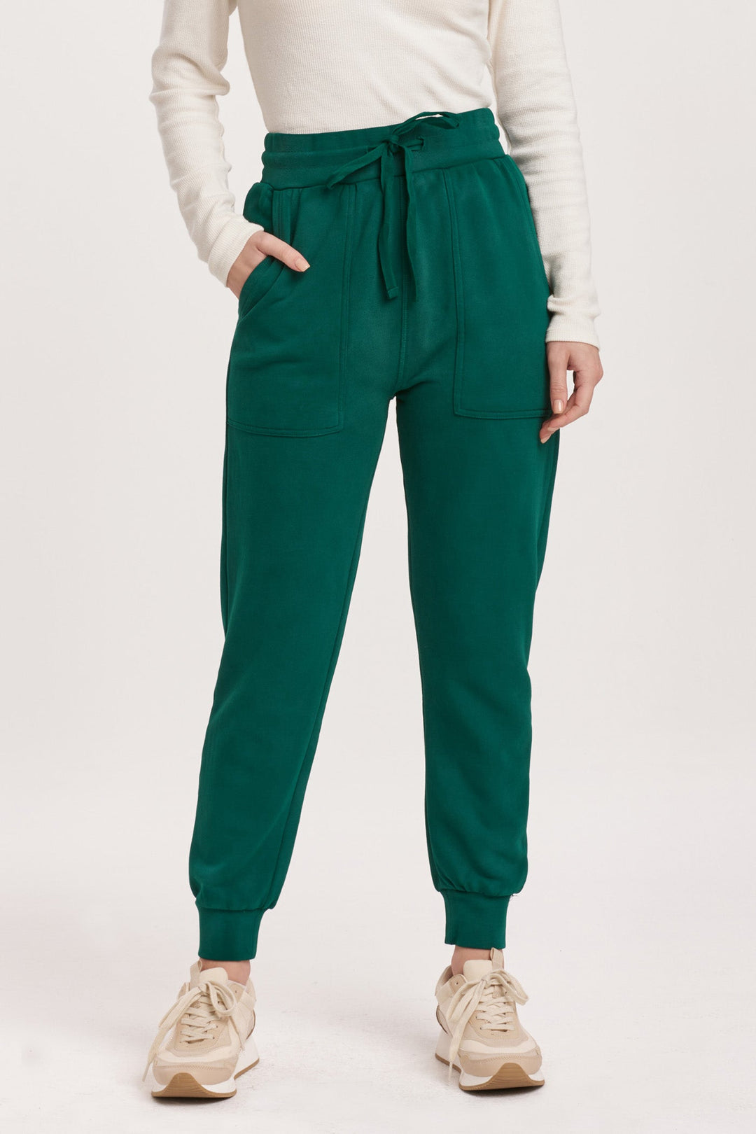 image of a female model wearing a DAHLIA HIGH RISE ANKLE JOGGER PANTS DEEP EMERALD DEAR JOHN DENIM 