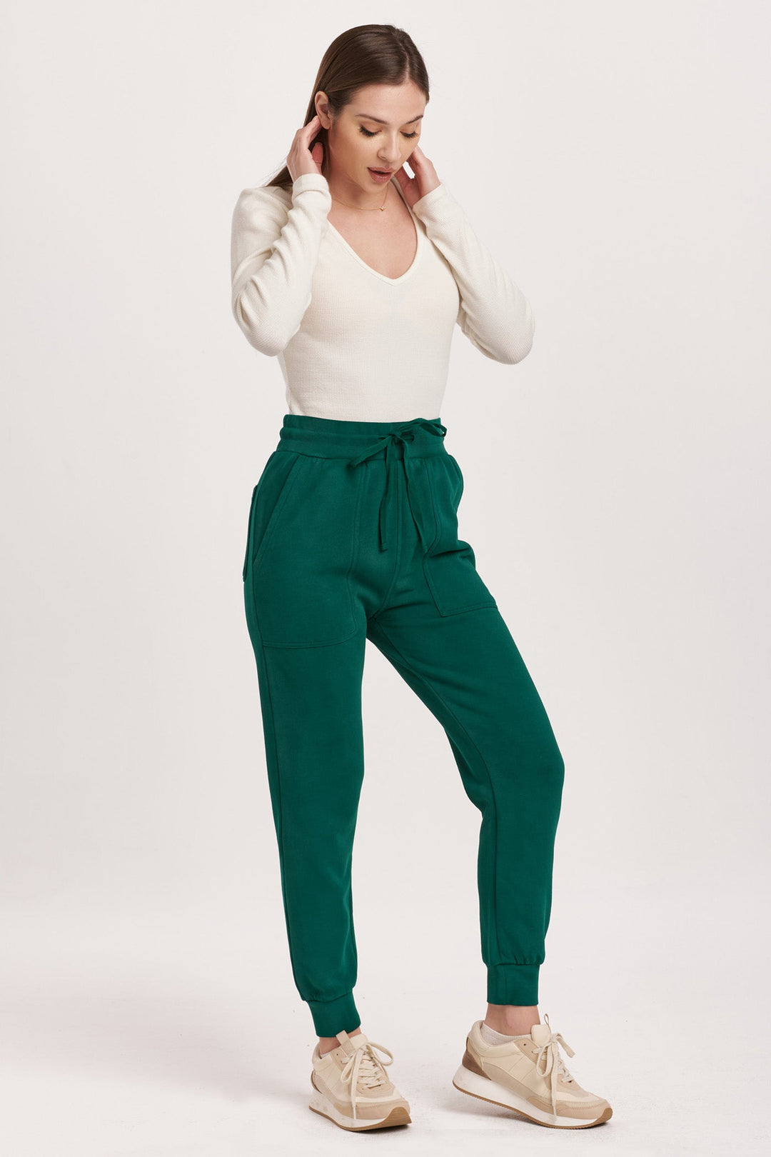 image of a female model wearing a DAHLIA HIGH RISE ANKLE JOGGER PANTS DEEP EMERALD DEAR JOHN DENIM 