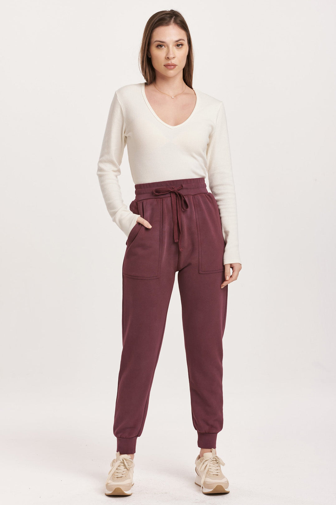 image of a female model wearing a DAHLIA HIGH RISE ANKLE JOGGER PANTS PLUM BERRY DEAR JOHN DENIM 