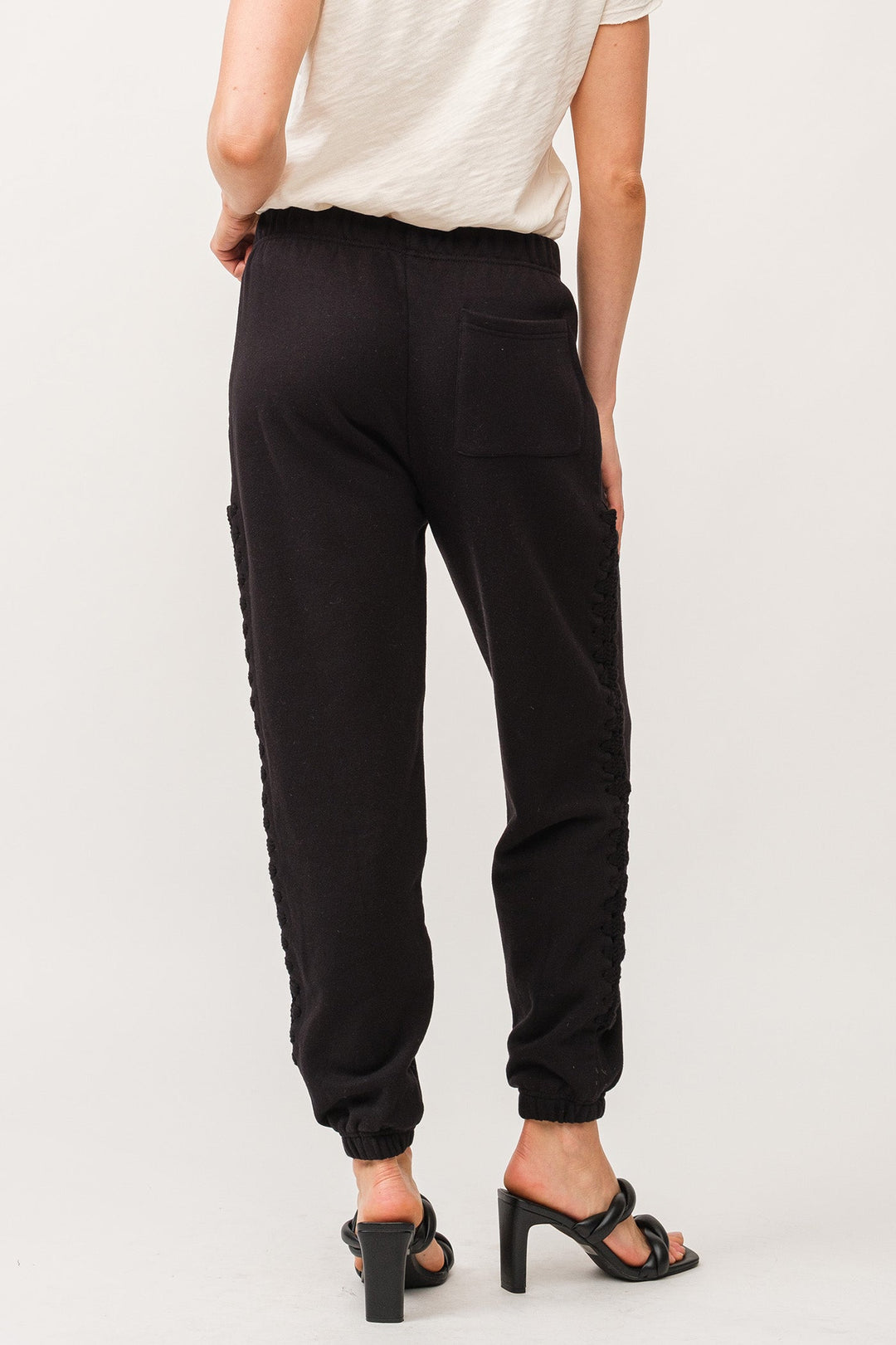 image of a female model wearing a KIMBERLY HANDMADE MACRAME DETAIL JOGGER PANTS BLACK DEAR JOHN DENIM 