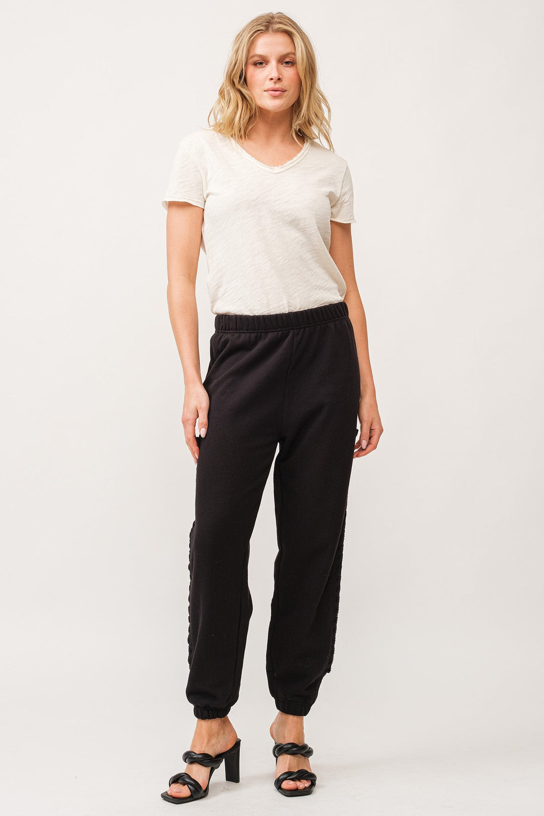 image of a female model wearing a KIMBERLY HANDMADE MACRAME DETAIL JOGGER PANTS BLACK DEAR JOHN DENIM 