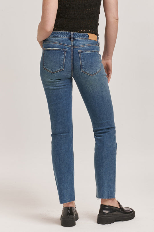 image of a female model wearing a PLAYBACK MID RISE SLIM STRAIGHT JEANS PHANTOM DEAR JOHN DENIM 