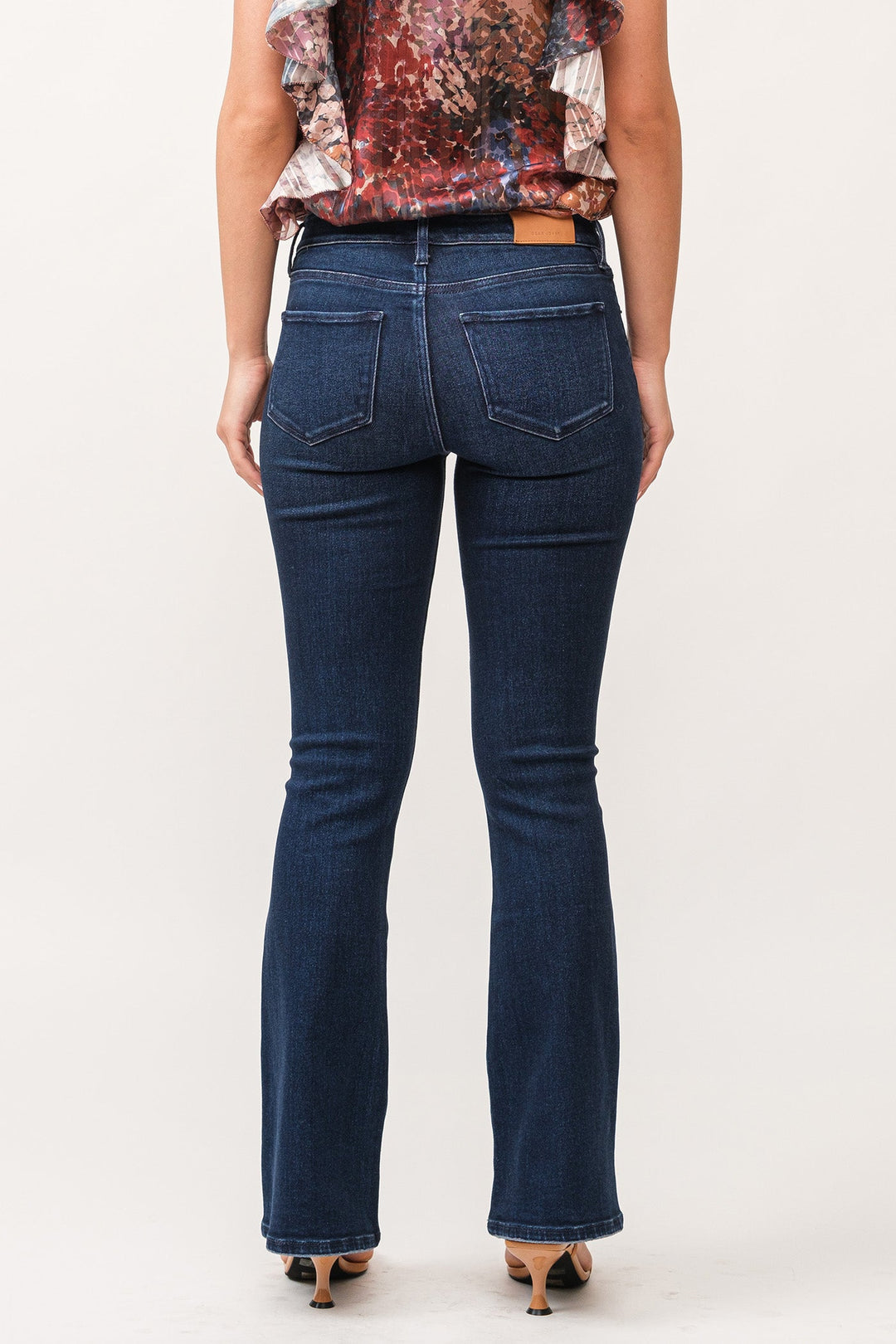 image of a female model wearing a JAXTYN MID RISE CLEAN HEM BOOTCUT JEANS BOSTON DEAR JOHN DENIM 