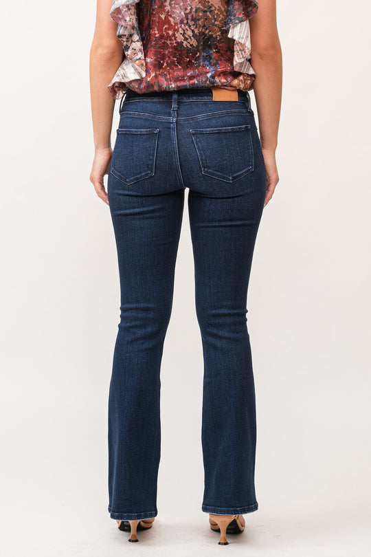 image of a female model wearing a JAXTYN MID RISE CLEAN HEM BOOTCUT JEANS BOSTON DEAR JOHN DENIM 