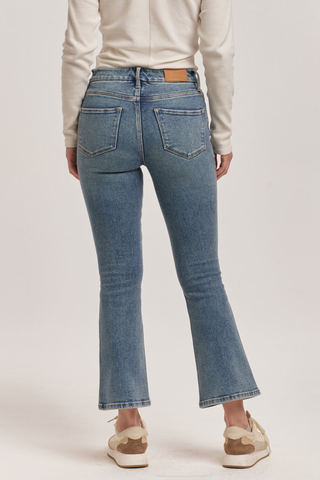 image of a female model wearing a JEANNE HIGH RISE CROPPED FLARE JEANS ANTIQUE WASH DEAR JOHN DENIM 