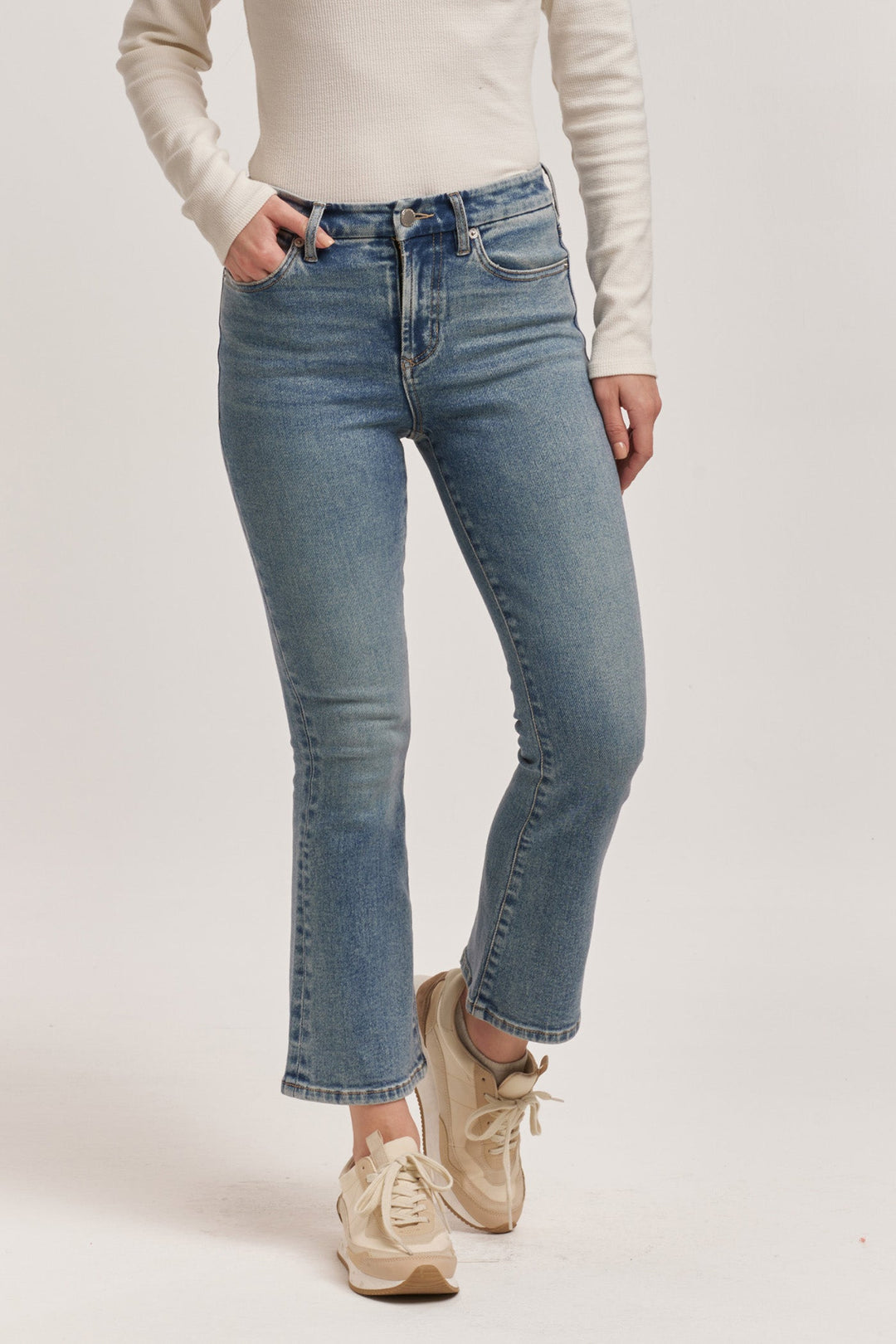 image of a female model wearing a JEANNE HIGH RISE CROPPED FLARE JEANS ANTIQUE WASH DEAR JOHN DENIM 