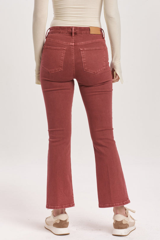 image of a female model wearing a JEANNE HIGH RISE CROPPED FLARE JEANS INTENSE RUST DEAR JOHN DENIM 