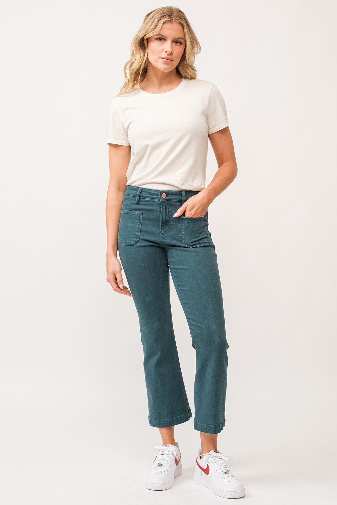 image of a female model wearing a JEANNE MID RISE CLEAN HEM FLARE JEANS DEEP TEAL DEAR JOHN DENIM 