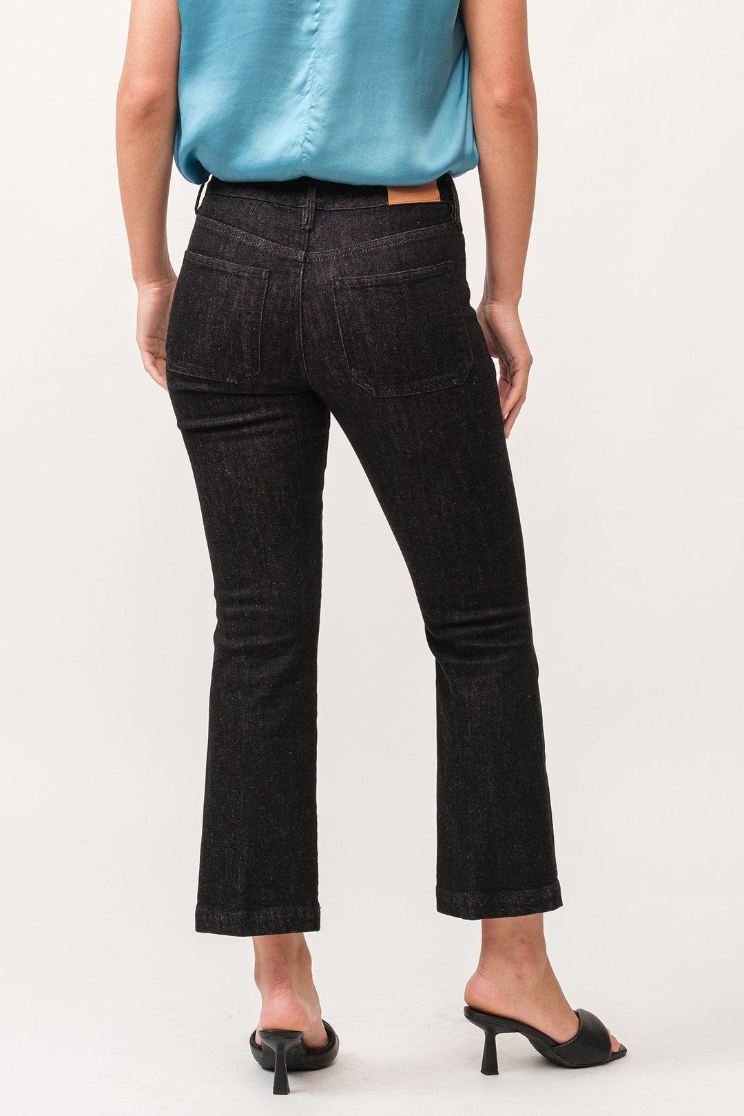 image of a female model wearing a JEANNE MID RISE CLEAN WIDE HEM FLARE PANTS TRUE BLACK DEAR JOHN DENIM 