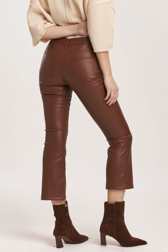 image of a female model wearing a JEANNE SUPER HIGH RISE CROPPED FLARE PANTS MAHOGANY VEGAN LEATHER DEAR JOHN DENIM 