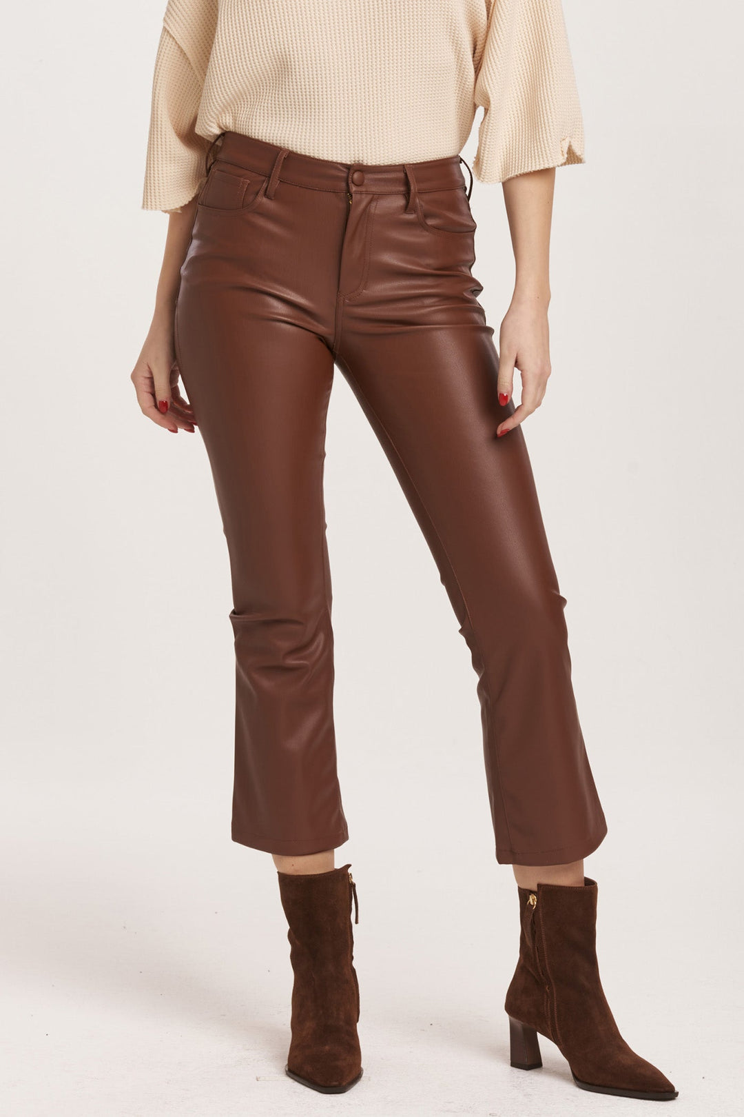 image of a female model wearing a JEANNE SUPER HIGH RISE CROPPED FLARE PANTS MAHOGANY VEGAN LEATHER DEAR JOHN DENIM 