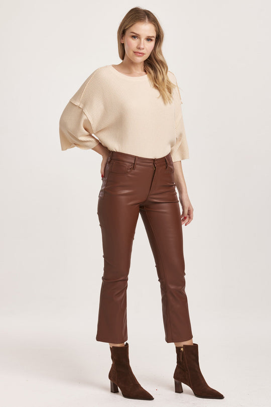 image of a female model wearing a JEANNE SUPER HIGH RISE CROPPED FLARE PANTS MAHOGANY VEGAN LEATHER DEAR JOHN DENIM 