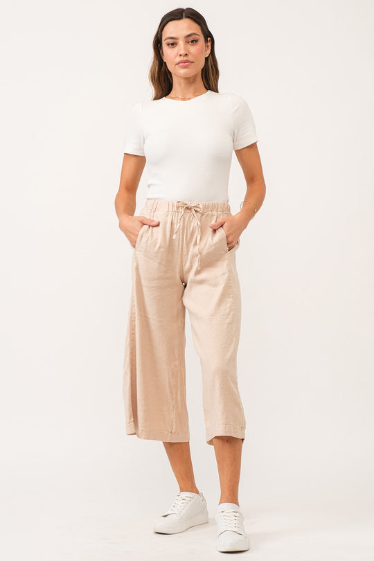 image of a female model wearing a ELINA SUPER HIGH RISE CROPPED WIDE LEG PANTS PEACH FLASH LINEN DEAR JOHN DENIM 