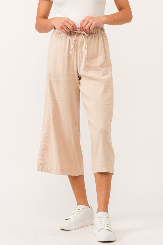 image of a female model wearing a ELINA SUPER HIGH RISE CROPPED WIDE LEG PANTS PEACH FLASH LINEN DEAR JOHN DENIM 