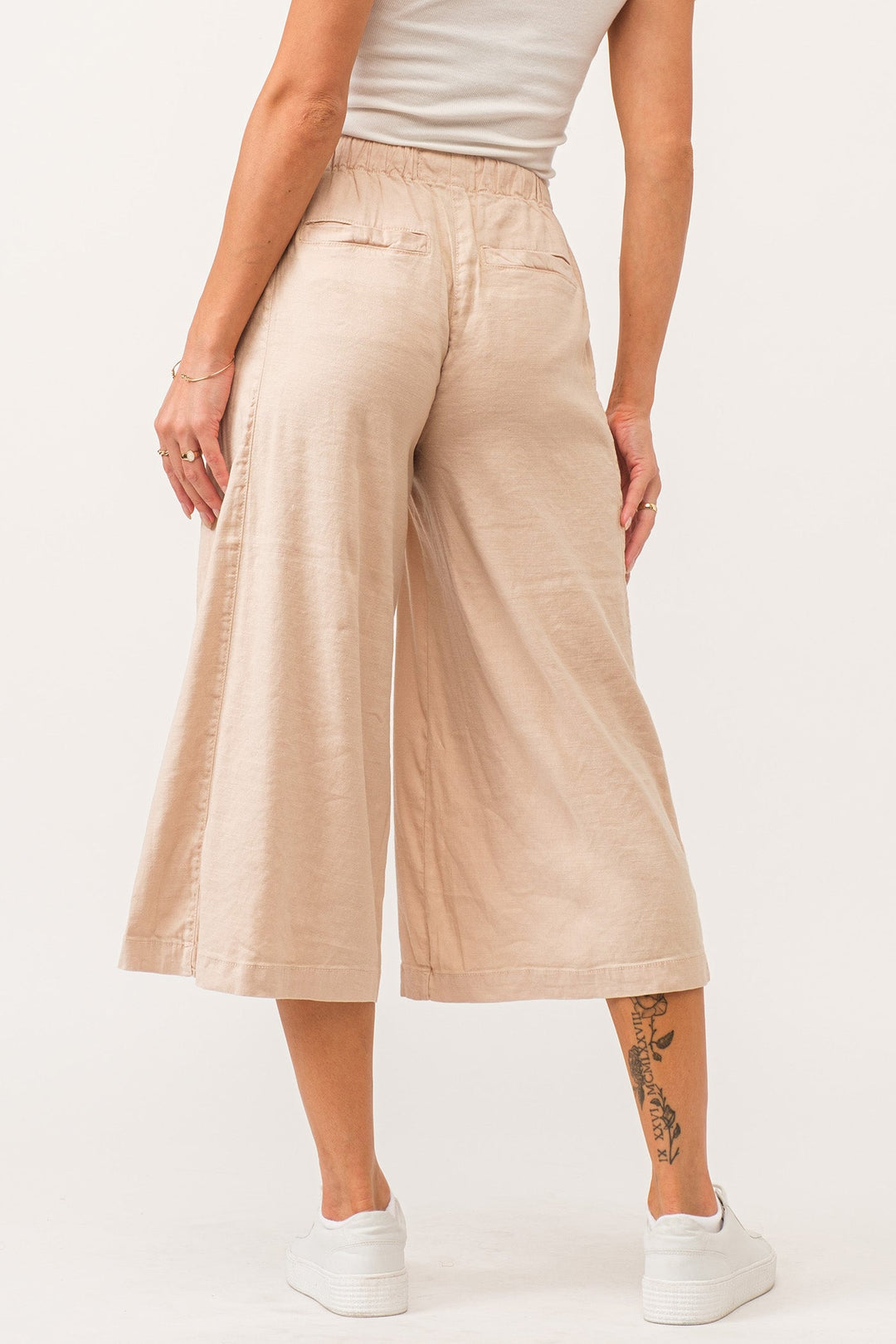 image of a female model wearing a ELINA SUPER HIGH RISE CROPPED WIDE LEG PANTS PEACH FLASH LINEN DEAR JOHN DENIM 