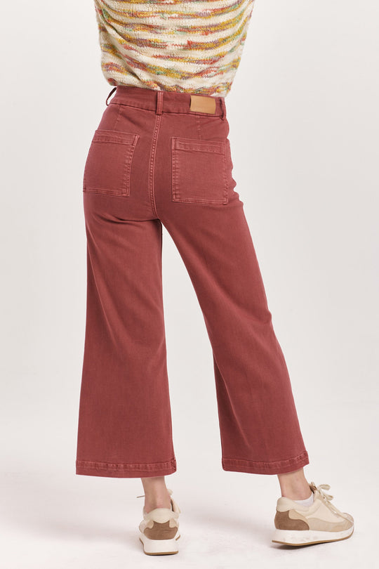 image of a female model wearing a AUDREY SUPER HIGH RISE CROPPED WIDE LEG COLOR JEANS INTENSE RUST DEAR JOHN DENIM 