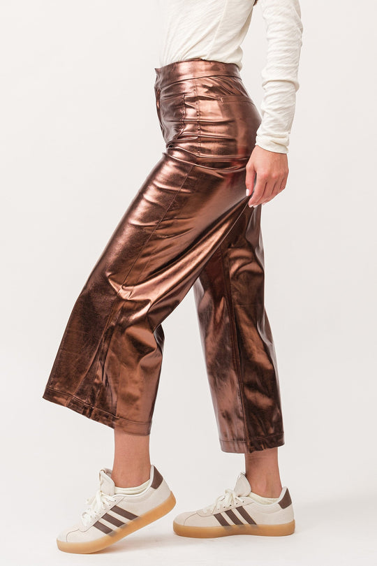 image of a female model wearing a AUDREY HIGH RISE WIDE CLEAN HEM PANTS RUST COPPER FOIL VEGAN LEATHER DEAR JOHN DENIM 