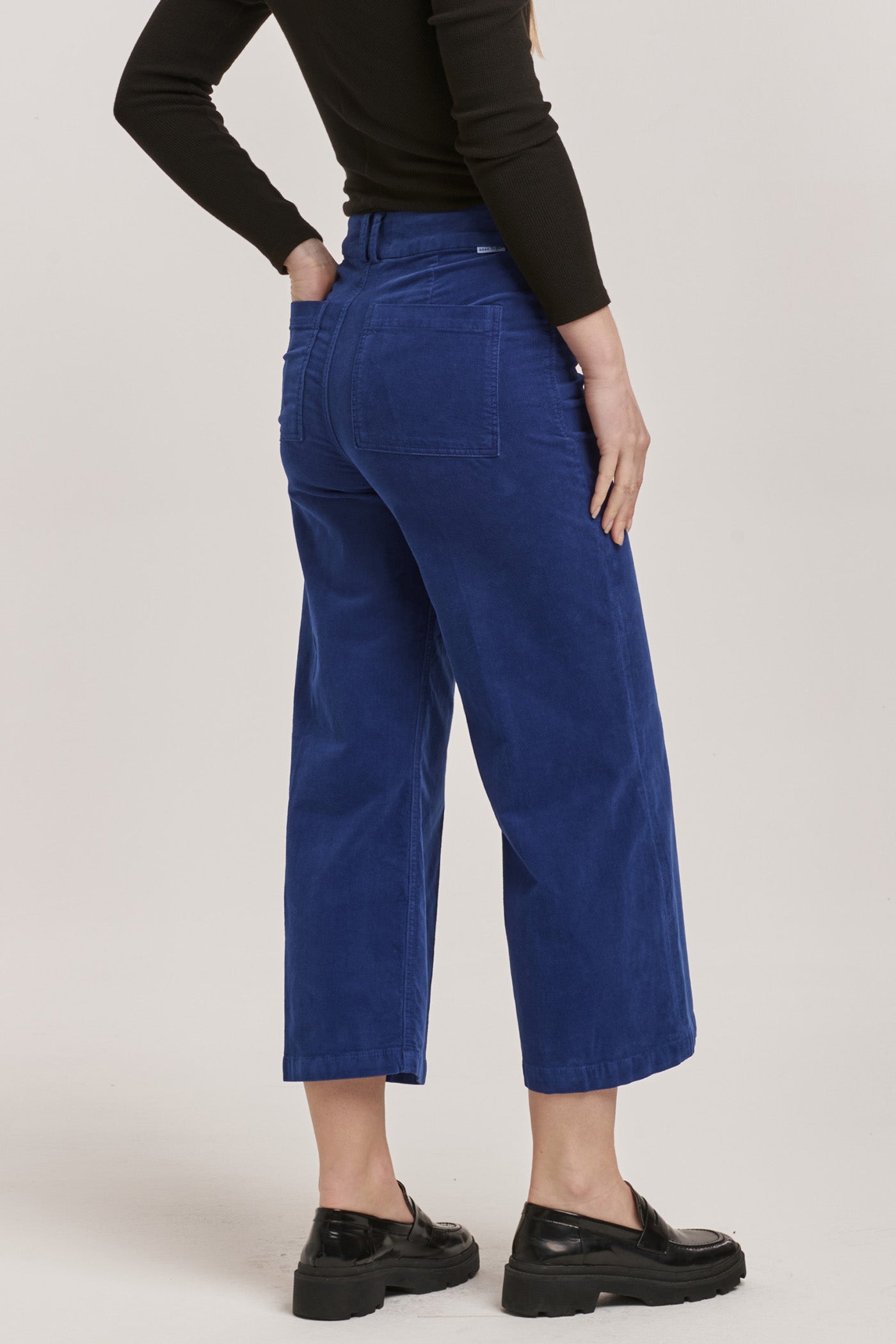 image of a female model wearing a AUDREY HIGH RISE CROPPED WIDE LEG PANTS ROYAL BLUE CORDUROY DEAR JOHN DENIM 