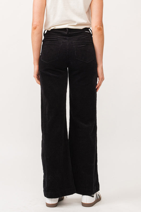 image of a female model wearing a FIONA HIGH RISE CLEAN HEM WIDE LEG PANTS BLACK CORDUROY DEAR JOHN DENIM 