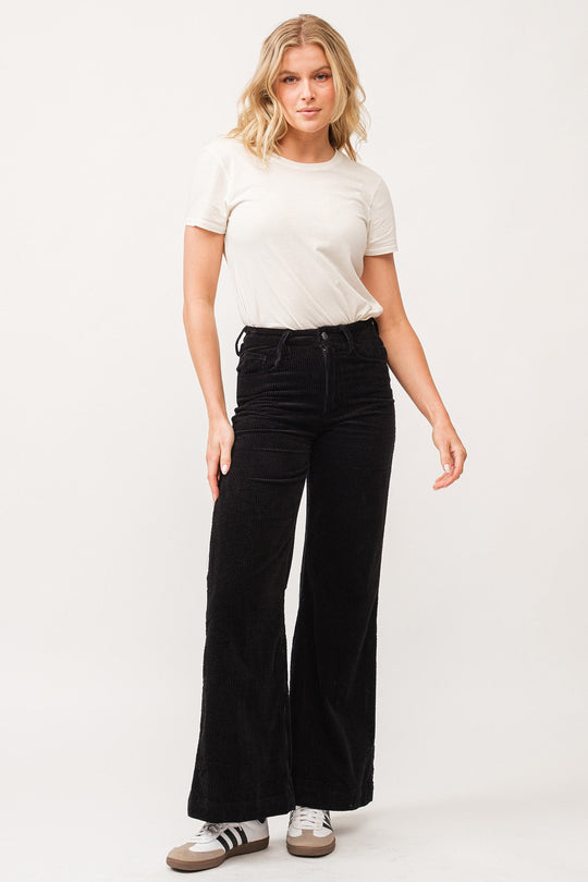 image of a female model wearing a FIONA HIGH RISE CLEAN HEM WIDE LEG PANTS BLACK CORDUROY DEAR JOHN DENIM 