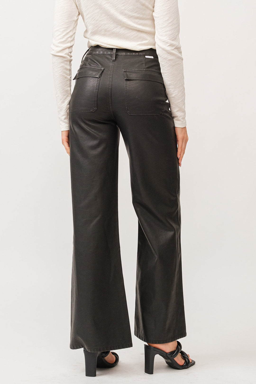 image of a female model wearing a FIONA HIGH RISE CLEAN HEM WIDE LEG PANTS SMOKED CHARCOAL VEGAN LEATHER DEAR JOHN DENIM 