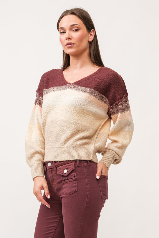 image of a female model wearing a LEXI V-NECK LONG SLEEVE RELAXED FIT SWEATER HOLIDAY MIMOSA DEAR JOHN DENIM 